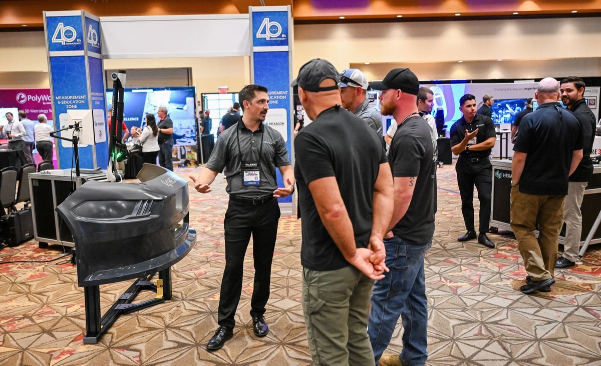 Attendees and exhibitors gathered at a booth in the CMSC exhibit hall