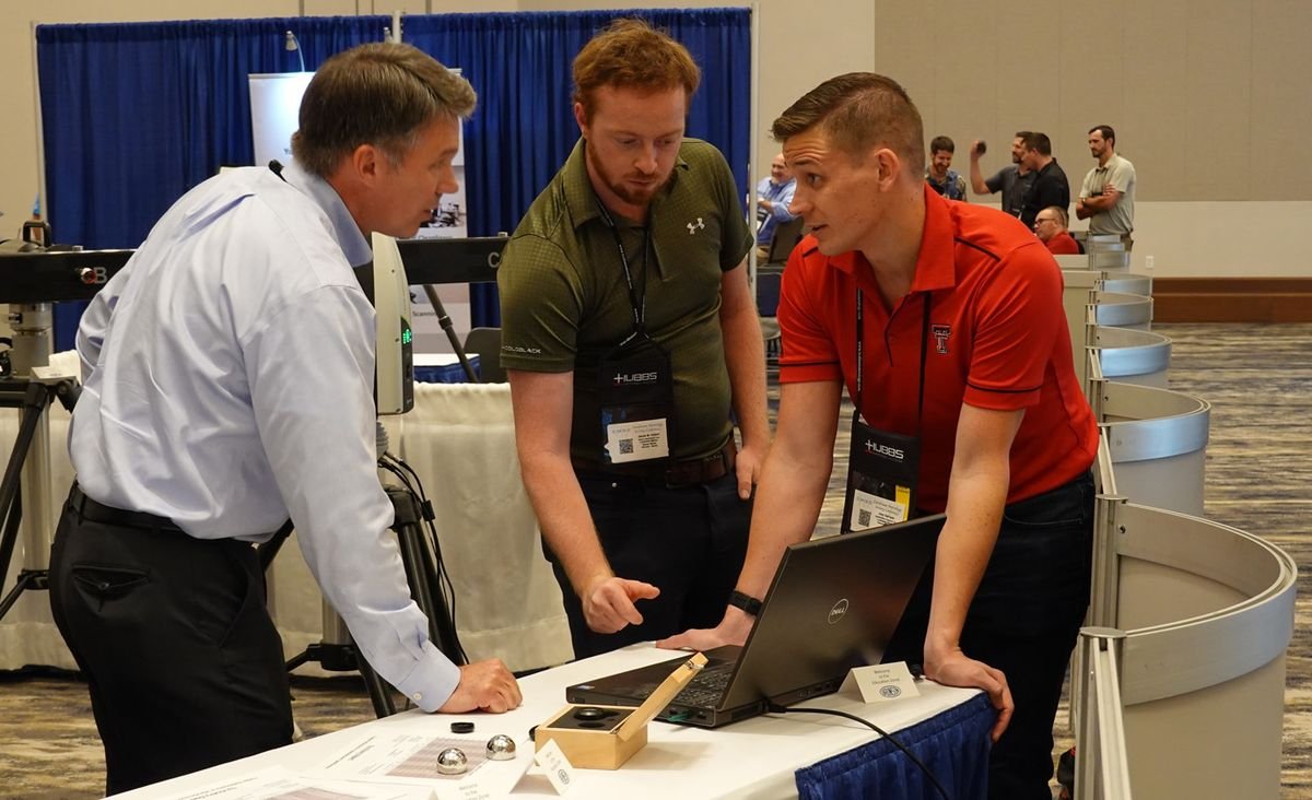 Professionals gathered around a hands-on product demonstration at CMSC