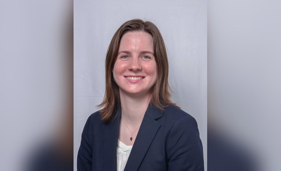 Katelyn Neese, CMS Foundation Board of Directors member, smiling in a navy blazer against a gray background